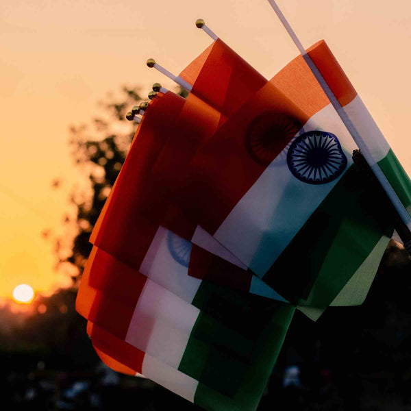 Indian flags at sunset - honor India's Independence Day with Romikas jewelry