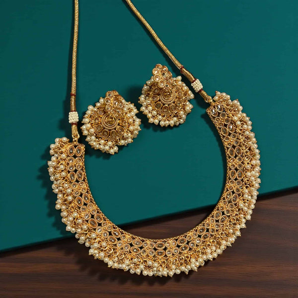 Guttapusalu temple jewelry necklace set in antique gold with high-quality Polki stones and dense pearl clusters. Traditional South Indian handcrafted design featuring cascading pearl bunches along the border. Perfect for brides and festive wear, this Polki and pearl necklace adds classic elegance to silk sarees, Kanjeevarams, and bridal outfits.