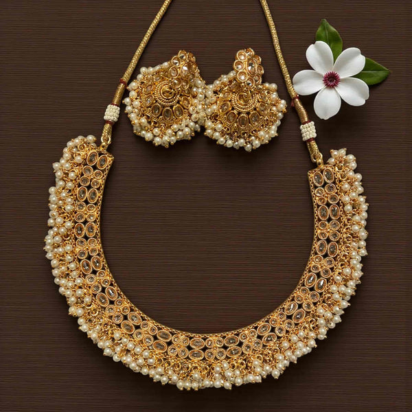 Antique gold Guttapusalu necklace set with brilliant Polki stones and handcrafted pearl clusters. Traditional temple jewelry style featuring the signature pearl fringe design. Perfect for South Indian bridal wear, wedding events, and festive occasions. Elegant Polki and pearl craftsmanship adds royal charm to silk sarees and lehengas.