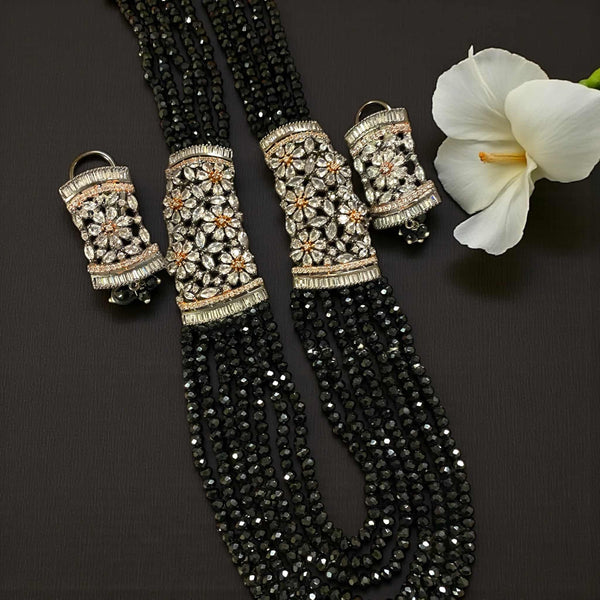 Black Pearl Mahima CZ Long Necklace Set with CZ Flowers | Elegant Indian jewelry featuring lustrous black pearls and sparkling cubic zirconia floral motifs in gold plating | Includes matching CZ floral earrings | Perfect for weddings, festive occasions, and evening celebrations | Traditional yet modern Indian jewelry by Romikas | Handcrafted statement set exuding sophistication, luxury, and timeless cultural charm