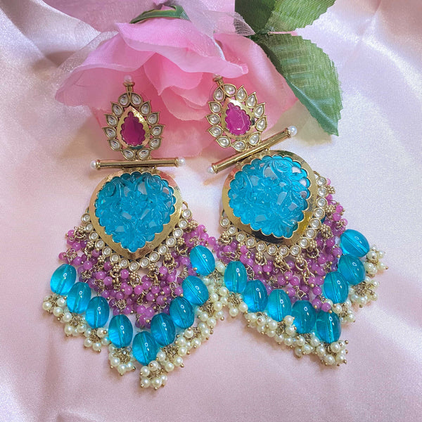 Featuring earrings from India these one of a kind blue ping earrings  showcases the beauty of Kundan with blue oink stones and pearls.