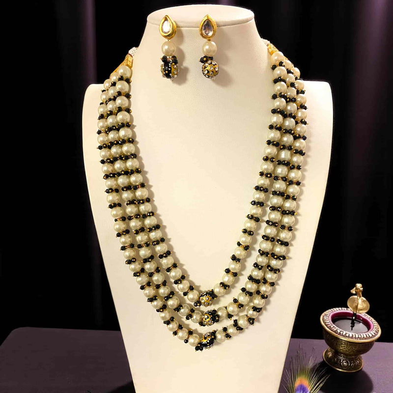 Jewelry mannequin displaying the Fatiha Long Pearl Necklace with Earrings, a multi-layer Indian pearl mala crafted with ivory pearls, black beads, Kundan stones, and Meenakari gold-plated accents. The matching Kundan pearl earrings are shown above the mala. Perfect traditional Indian bridal and festive necklace set for weddings, parties, and ethnic fashion styling.
