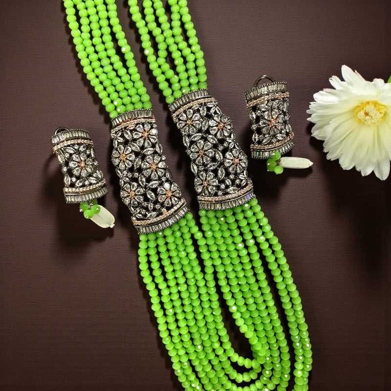 Parrot Green Pearl Mahima CZ Long Necklace Set with CZ Flowers | Elegant Indian jewelry featuring vibrant parrot green pearls and sparkling cubic zirconia floral motifs | Gold-plated long necklace paired with matching CZ floral earrings | Perfect for weddings, festive occasions, and bridal celebrations | Styled with sarees or lehengas | Handcrafted Romikas jewelry blending traditional Indian artistry with modern sophistication and radiant charm
