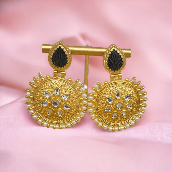 These earrings showcase intricately embedded Kundan, adding a touch of timeless tradition to your ensemble. The outer layer graces pearls, bringing an element of refined sophistication.