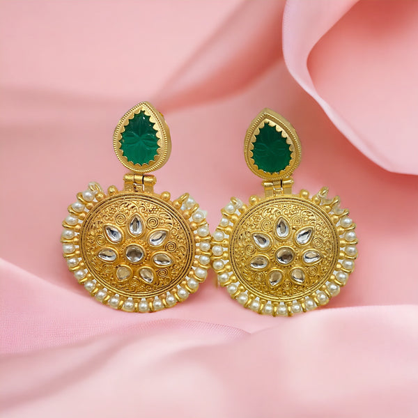 Embrace the allure of the East with the captivating Emerald Amrapali stone that takes center stage, radiating with a lush green hue that symbolizes prosperity and natural beauty. The intricate design of these earrings captures the essence of tradition while making a bold statement in the world of fashion.