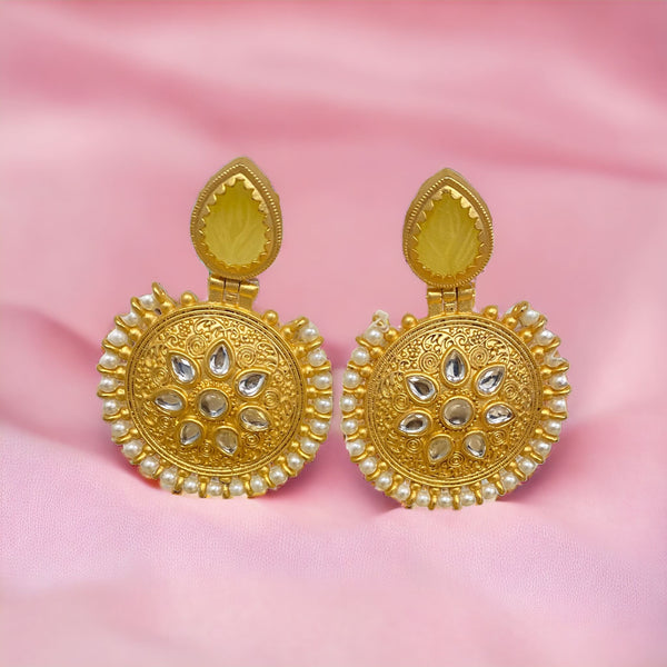 Elevate your style with our captivating Gold Kundan Earrings, a seamless blend of Desi elegance and Pakistani jewelry craftsmanship. These earrings feature intricately embedded Kundan, adding a touch of traditional allure. The outer layer is adorned with pearls, enhancing the overall sophistication.