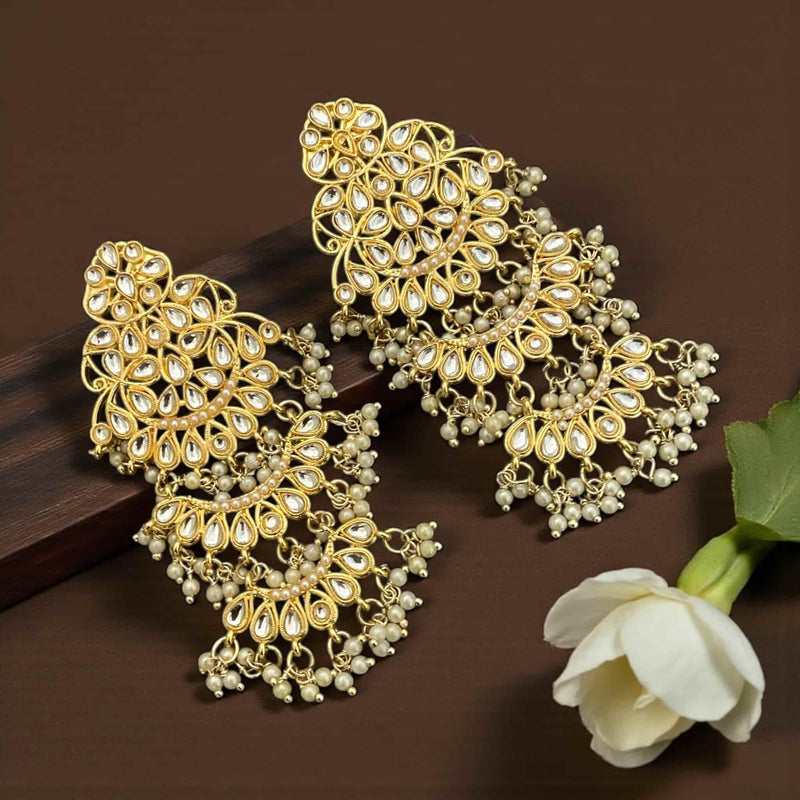 High quality gold plated Kundan chandbali earrings with pearl drops, showcasing intricate handcrafted detailing inspired by traditional Indian jewelry. These earrings feature shimmering Kundan stones set in a premium gold finish with delicate pearl hangings that add elegance and movement. Perfect for bridal wear, wedding guests, festive outfits, and cultural celebrations, these earrings complement sarees, lehengas, anarkalis, and Indo-western styles. A luxurious South Asian jewelry piece designed for women 