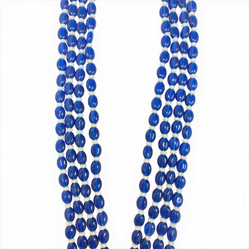 The Royal Blue Monalisa beads in this Kundan Necklace Set add a luxurious touch with their rich color and smooth, polished shine. Arranged in multiple strands, these beads enhance the regal charm of the gold-plated pendant and earrings. Their deep blue hue beautifully contrasts with the Kundan and Polki detailing, creating a timeless and elegant look perfect for Indian weddings, bridal wear, and festive celebrations.
