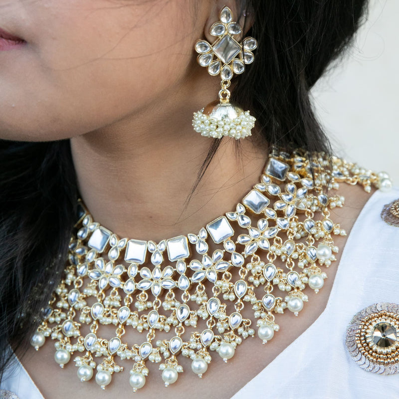 Model wearing Indan Jewelry featuring Kundan necklace with high quality kundan and pearls with jhumkas from Indian jewelry store in California.