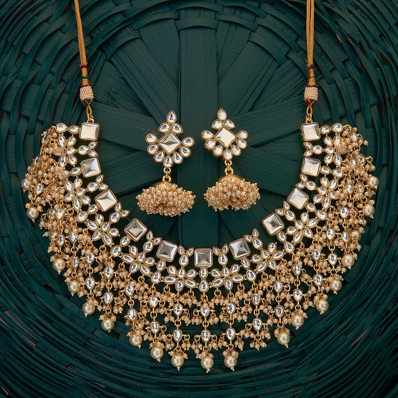 Indian Kundan Necklace Set with pearls and jhumkas on gold plating.