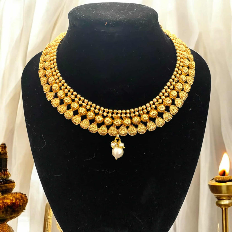 Gold-plated necklace with pearls, featuring intricate traditional Indian craftsmanship. This elegant necklace is perfect for bridal wear, weddings, and festive occasions. Designed to complement sarees, lehengas, and other ethnic outfits, the classic pearl detailing adds timeless charm. A must-have in any South Asian jewelry collection, this statement gold and pearl necklace blends heritage with sophistication, making it ideal for cultural celebrations and special events.