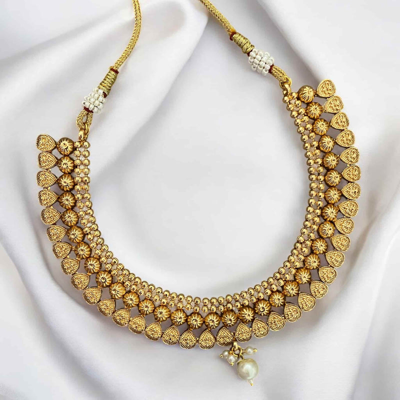 Gold-plated necklace with pearls featuring intricate traditional Indian design. Perfect for bridal wear, weddings, and festive occasions. This elegant ethnic necklace pairs beautifully with sarees, lehengas, and other South Asian outfits. Classic pearl accents add timeless charm, making it an ideal choice for cultural celebrations and special events. A must-have statement piece in any ethnic jewelry collection for women who love gold and pearl combinations.