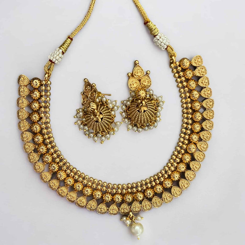 Traditional gold-plated necklace set with pearls and matching jhumka earrings, perfect for Indian weddings and festive occasions. The necklace features intricate detailing and elegant pearl accents, while the coordinating jhumkas offer a classic bell-shaped design. Ideal for pairing with sarees, lehengas, and other ethnic wear, this jewelry set adds a touch of regal charm to any look. A stunning choice for brides and anyone seeking timeless South Asian elegance.