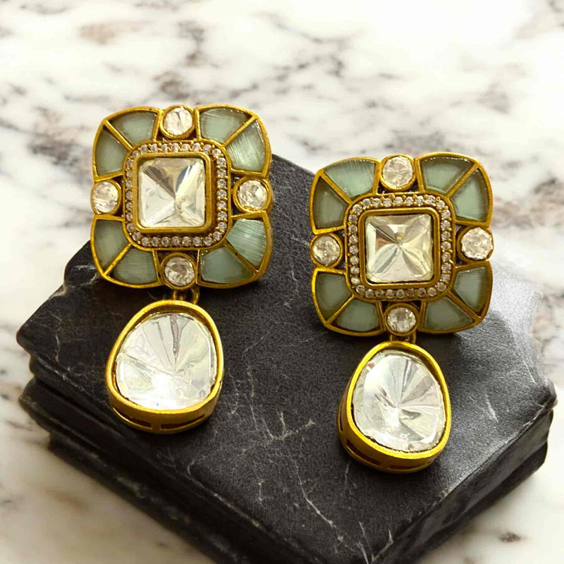 Malika gold plated drop earrings with moissanite stones and teal doublet gems from Romikas Jewelry. Matching chandelier earrings feature floral stud tops with brilliant moissanite crystals, sage green doublet stones, and elegant teardrop dangles. Traditional Indian kundan style bridal earrings, ethnic wedding jewelry, artificial diamond earrings, costume jewelry accessories. Statement drop earrings perfect for Hindu weddings, reception parties, festive occasions. Designer fashion earrings for women.