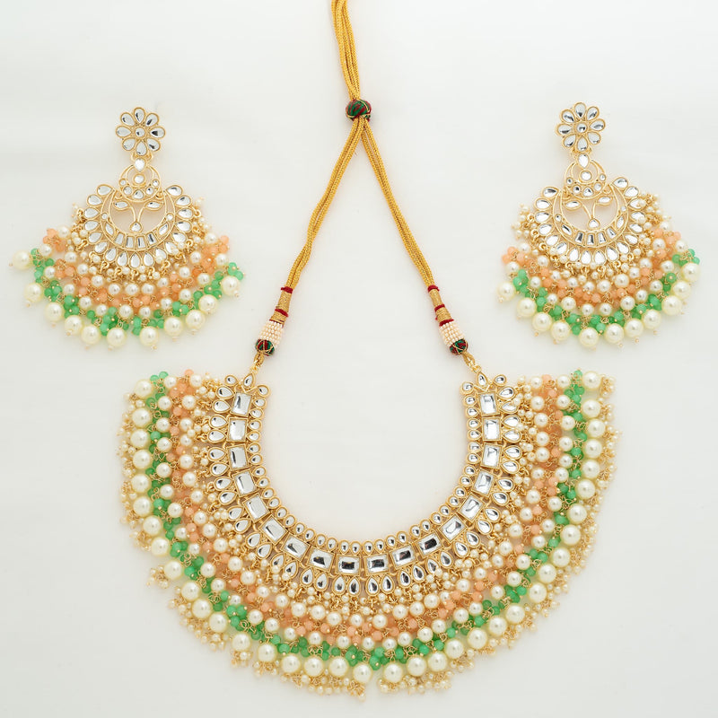 Adjustable Kundan Necklace Set featuring Indian Jewelry made of high quality kundan, mint and pink beads and pearls. Set comes with a necklace and earrings.