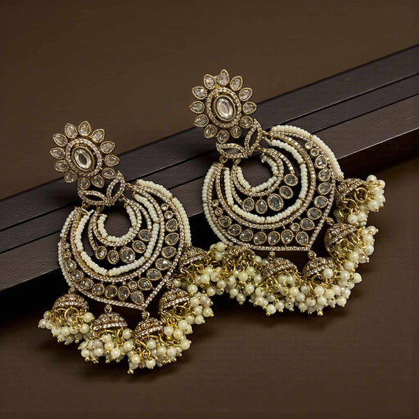 High quality Kundan and pearl gold plated chandbali earrings with intricate detailing and traditional Indian design. Featuring floral Kundan motifs, crescent shapes, and delicate pearl clusters, these earrings blend elegance and heritage. Perfect for weddings, parties, and festive occasions, they pair beautifully with sarees or lehengas. A stunning example of handcrafted Polki-style Indian jewelry for brides and ethnic jewelry lovers.