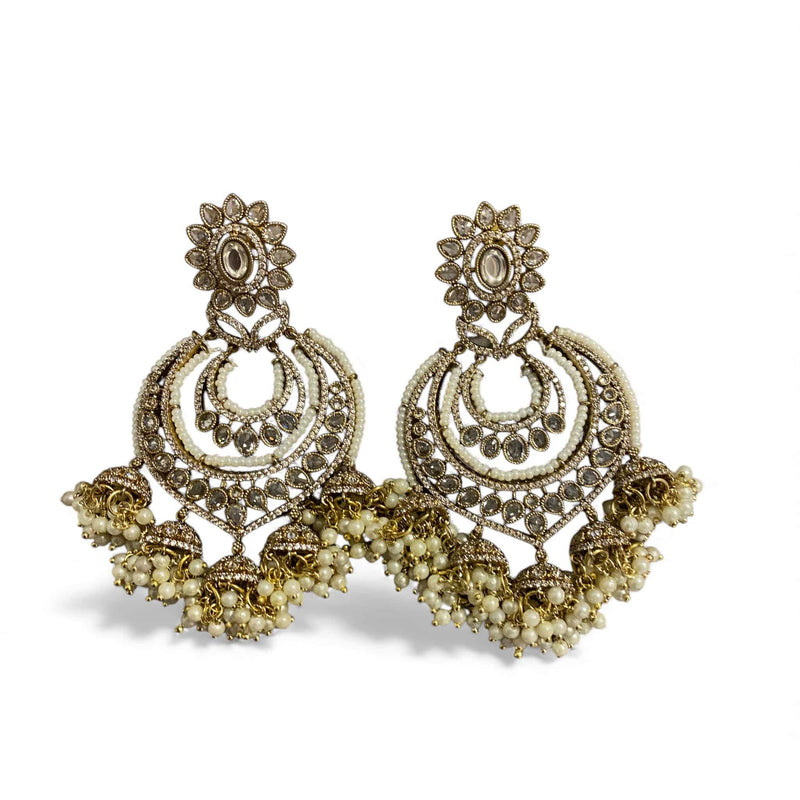 High quality Kundan and pearl gold plated chandbali earrings designed for women who love elegant Indian jewelry with a touch of luxury. Featuring hand-set Kundan stones, Polki-inspired detailing, and graceful pearl drops, these earrings make a timeless statement. Ideal for parties, receptions, and festive wear, they pair beautifully with gowns, sarees, and fusion outfits. Perfect for those who appreciate classic Indian craftsmanship with a modern, sophisticated appeal.