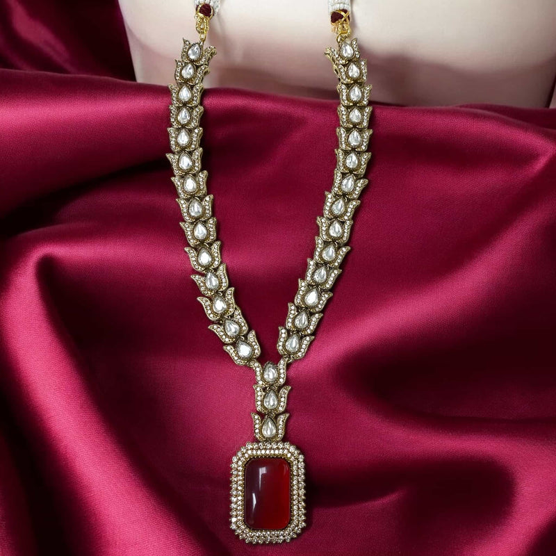 Exquisite Kundan and Cubic Zirconia necklace set in a striking black finish, featuring a bold ruby centerpiece. Includes matching earrings for a regal touch. Perfect for bridal, wedding, and festive wear, this statement piece adds elegance to any South Asian jewelry collection.