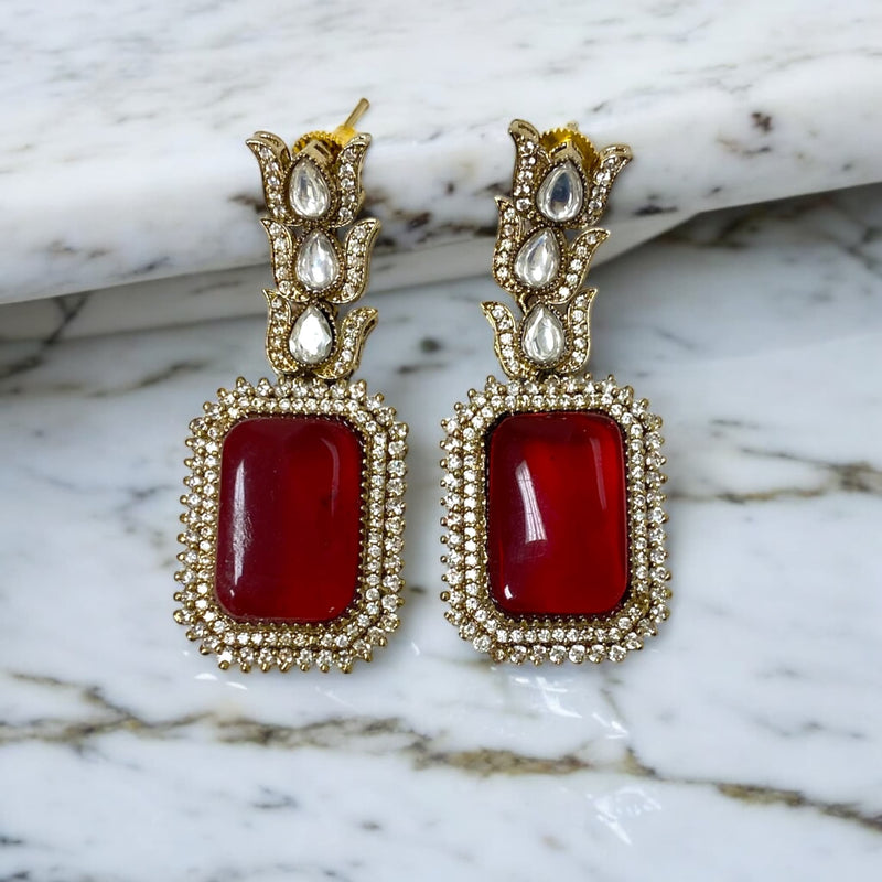 Elegant Kundan and Cubic Zirconia earrings in black finish with a striking ruby stone. Perfect for weddings, festive occasions, and South Asian bridal wear. A blend of traditional craftsmanship and modern elegance, ideal for statement jewelry lovers.