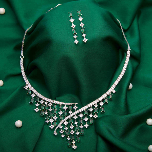 Online Bollywood jewelry featuring white and emerald cz stones made unti a necklace with earrings.