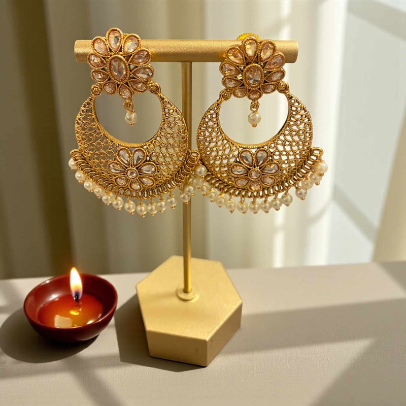 Stunning Gold Polki Chandbali Earrings with Pearls featuring intricate floral motifs and shimmering Polki stones. Crafted in a rich gold finish, these traditional Indian earrings exude elegance and heritage. The delicate pearl drops add a graceful touch, making them perfect for weddings, parties, and festive occasions. Ideal for pairing with sarees, lehengas, and bridal outfits, these earrings bring timeless beauty and sophistication to any ethnic look.
