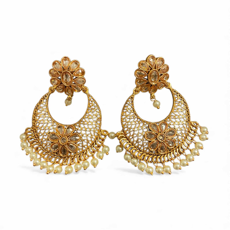 Elegant Gold Polki Chandbali Earrings adorned with pearls and detailed floral patterns. These handcrafted Indian earrings feature a stunning crescent design with intricate gold filigree and Polki stones for a royal touch. Perfect statement jewelry for brides, festive occasions, and traditional wear like sarees or lehengas. Adds timeless grace and sophistication to any ethnic or wedding ensemble.