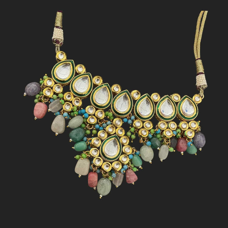Multicolor Kundan necklace featuring high-quality Kundan stones and vibrant natural gemstones in red, green, and blue. Intricate traditional Indian craftsmanship with detailed meenakari work on the back. Gold-plated finish enhances its elegance and durability. Perfect for weddings, festivals, and ethnic occasions. This statement necklace complements bridal and festive outfits with its rich colors and timeless design.