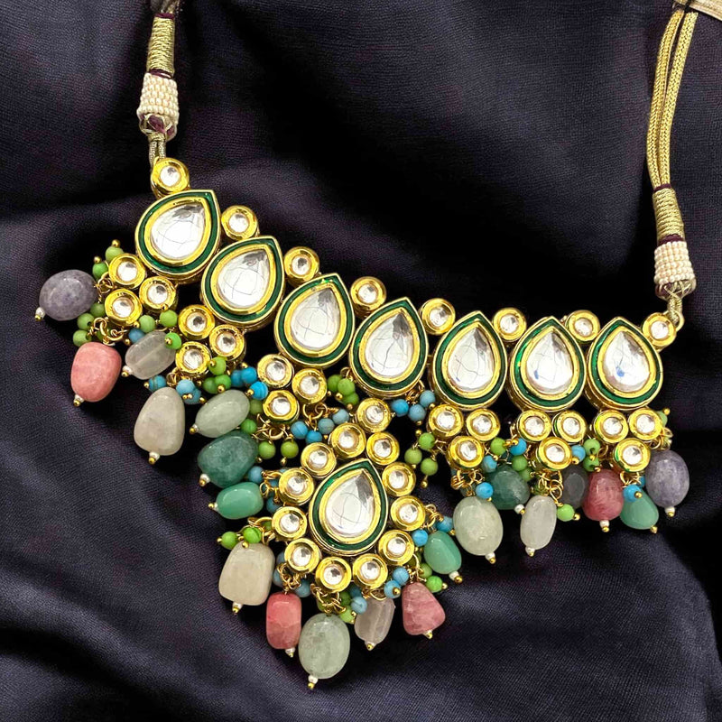 Beautiful multicolor Kundan necklace adorned with vibrant natural stones and exquisite Kundan craftsmanship. Features intricate meenakari work on the back for an authentic traditional touch. Gold-plated with a rich finish, ideal for bridal wear, festive occasions, and ethnic celebrations. Perfect accessory to elevate sarees, lehengas, and other traditional Indian outfits with elegance and cultural charm.