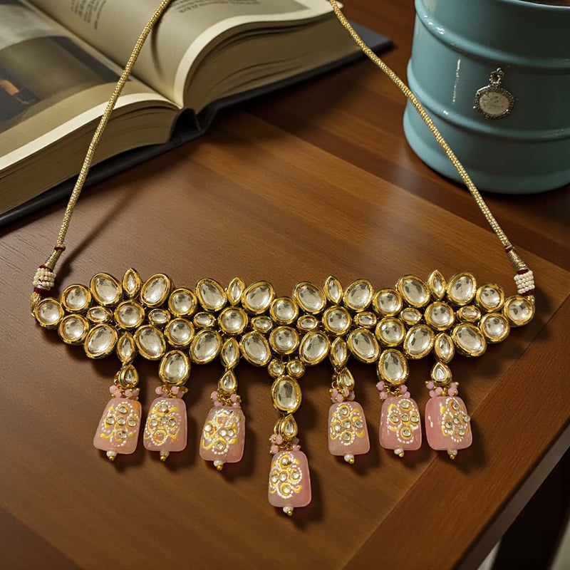 Exquisite Kundan choker necklace with pink Monalisa beads and detailed back meenakari work, gold-plated finish, showcasing traditional Indian jewelry craftsmanship. Perfect for weddings, bridal events, festivals, and ethnic occasions, this premium necklace offers a stunning statement piece for festive celebrations, South Asian cultural events, and elegant attire, combining intricate Kundan design, vibrant beads, and luxurious ethnic appeal for timeless style and sophistication.
