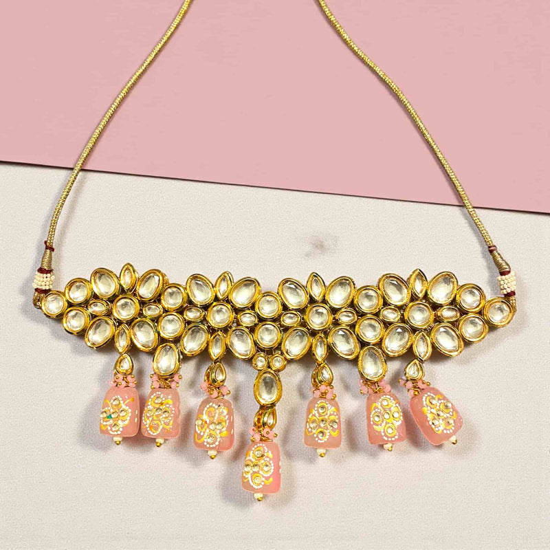 Elegant Pink Kundan Choker Necklace handcrafted with shimmering Kundan stones and soft pink Monalisa beads in a luxurious gold-plated finish. The back features intricate Meenakari enamel work, showcasing fine Indian artistry. Perfect for brides and festive occasions, this traditional Kundan necklace pairs beautifully with sarees and lehengas, adding a royal and sophisticated touch to any South Asian wedding or celebration look.