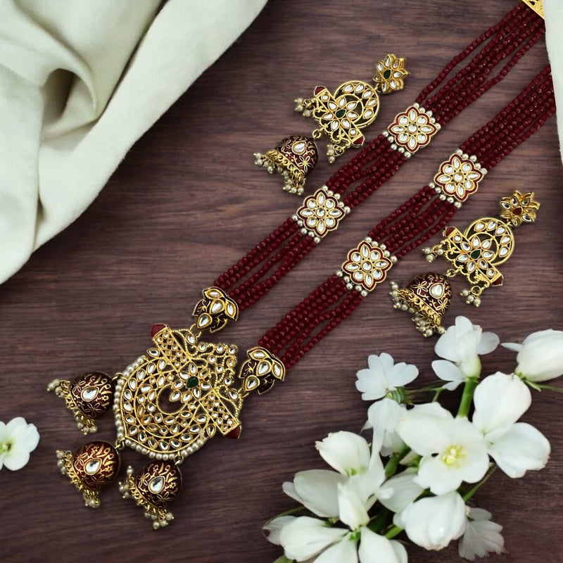Pritha Maroon Kundan long necklace set with pearls, gold-plated finish, and intricate meenakari work. Includes matching earrings. Traditional Indian bridal jewelry perfect for weddings, festive occasions, and cultural events. Elegant South Asian necklace set with rich maroon beads and handcrafted details. Ideal for brides, bridesmaids, and wedding guests. Adds a regal touch to any ethnic outfit.