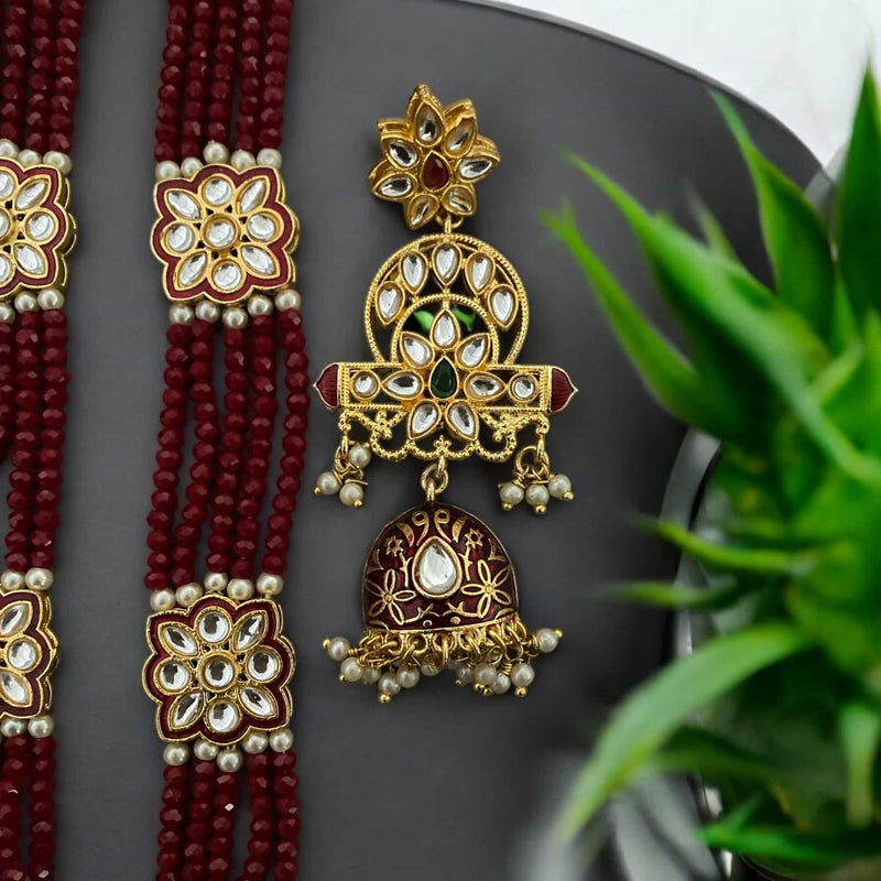 Pritha Maroon Kundan long necklace set featuring gold-plated accents, intricate meenakari work, and pearl detailing. The set includes matching earrings, making it perfect for bridal jewelry, Indian weddings, and festive occasions. Handcrafted with rich maroon beads and traditional Kundan craftsmanship, this South Asian jewelry set adds elegance and sophistication to any ethnic outfit. Ideal for brides, bridesmaids, and wedding guests seeking timeless and luxurious jewelry.