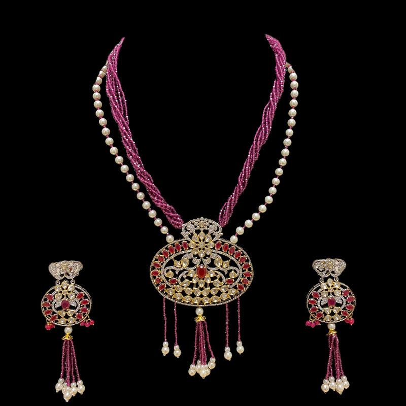 Long Necklace with a strand of pearl and a nstrand of purple beads with a pendant of silever foil/pachi kundan and ruby crystals with dangling purple beads and pearl. 