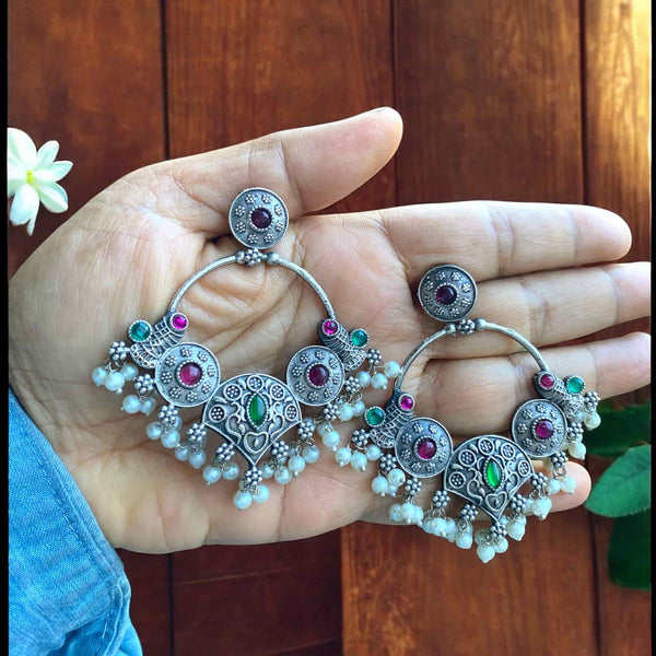 High-quality German silver Chandbali earrings featuring intricate design with ruby and green stones, accented with pearls. Traditional South Asian ethnic earrings with oxidized silver finish, perfect for Indian weddings, festivals, and cultural events. Handmade Indian jewelry inspired by antique temple styles. Statement earrings for lehenga, saree, or salwar suit. Bridal and festive jewelry must-have for women seeking bold ethnic elegance.