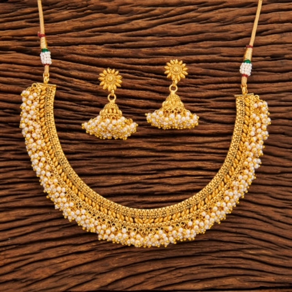 Traditional Indian Antique Gold Necklace Set With Pearl. It comes with jhumkas. This set showcases South Indian Necklace with gajra style pearl.