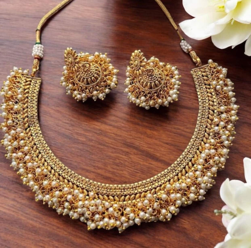 Antique Gold Gutapusulu Necklace Set with Pearls | Traditional South Indian Jewelry featuring intricate temple design and handcrafted detailing | Elegant gold-plated necklace with matching earrings adorned with delicate pearl clusters | Perfect for weddings, festive occasions, and bridal wear | Exquisite ethnic jewelry inspired by timeless craftsmanship and cultural heritage.