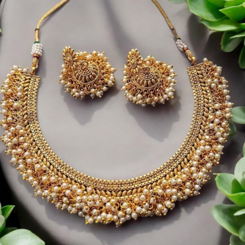 Traditional Antique Gold Gutapusulu Necklace Set with Pearls featuring intricate craftsmanship and detailed gold filigree design. The necklace is adorned with layers of tiny pearl clusters for a rich, regal look, paired with matching earrings. Perfect for weddings, festivals, and South Indian bridal wear, this handcrafted jewelry set embodies elegance, heritage, and timeless beauty — a must-have for your ethnic jewelry collection.