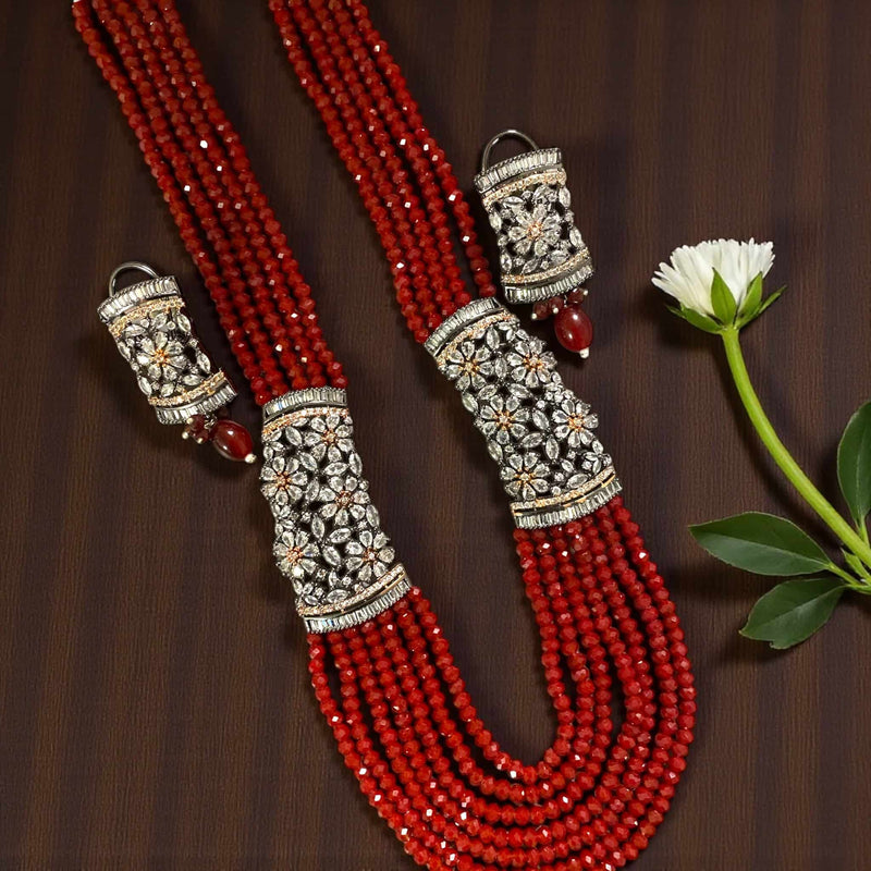 Red Pearl Mahima CZ Long Necklace Set with CZ Flowers | Indian jewelry featuring deep red pearls and sparkling cubic zirconia floral motifs | Gold-plated long necklace with matching earrings | Perfect for weddings, festive occasions, and bridal ensembles | Traditional yet elegant design blending classic Indian craftsmanship with modern sophistication | Statement jewelry set by Romikas adding regal charm and timeless beauty to any outfit