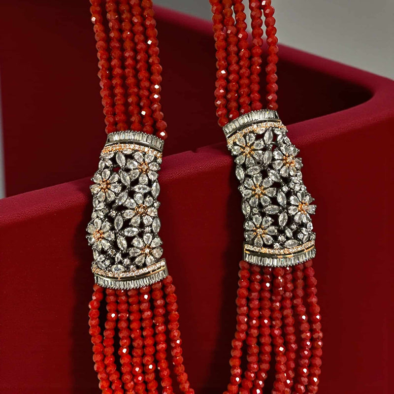 Red Pearl Mahima CZ Long Necklace with CZ Flowers | Indian jewelry featuring deep red pearls and sparkling cubic zirconia floral motifs | Gold-plated elegant long necklace | Perfect for weddings, festive occasions, and bridal ensembles | Traditional yet modern design blending classic Indian craftsmanship with contemporary style | Statement necklace by Romikas | Adds regal charm, sophistication, and timeless beauty to any outfit