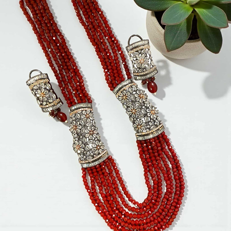 Red Pearl Mahima CZ Long Necklace Set with CZ Flowers | Complete Indian jewelry set featuring vibrant red pearls and sparkling CZ floral motifs | Gold-plated long necklace paired with matching earrings | Perfect for weddings, festive occasions, and bridal celebrations | Blends traditional Indian elegance with modern style | Handcrafted Romikas masterpiece showcasing intricate detailing, timeless beauty, and statement-making sophistication | Adds a regal, luxurious touch to any outfit