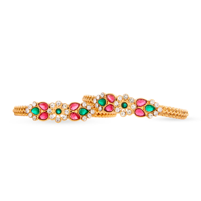 Pakistani Bangles in gold with kundan, red and green stones.