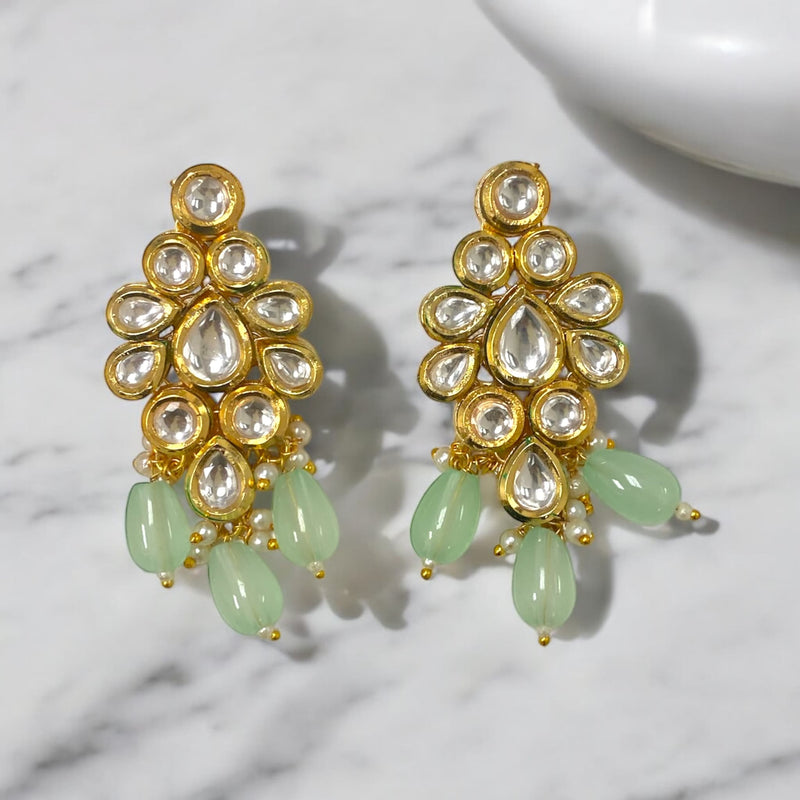 These exquisite mint Kundan earrings feature intricate craftsmanship, making them ideal for bridal jewelry and traditional Indian attire.Perfect for weddings,haldi ceremonies, and festive occasions, these earrings elevate your look. The refreshing mint hue beautifully complements a variety of outfits, adding elegance and charm.A must-have for any online Indian jewelry collection, these luxurious earrings blend timeless beauty with contemporary style, ensuring you make stunning statement on your special day.