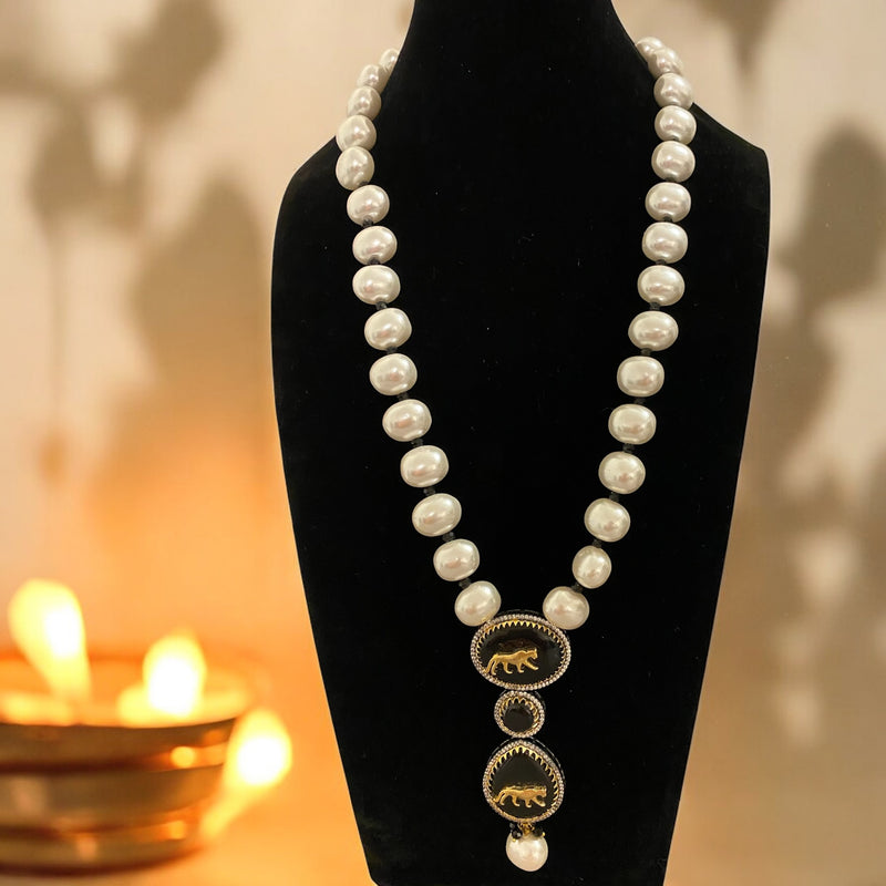 Sabyasachi-inspired long necklace set with baroque pearls, black stone pendant, and tiger motif. Matching earrings with intricate design, pearls, and black stone. Perfect for bridal wear, festive events, and traditional Indian celebrations.