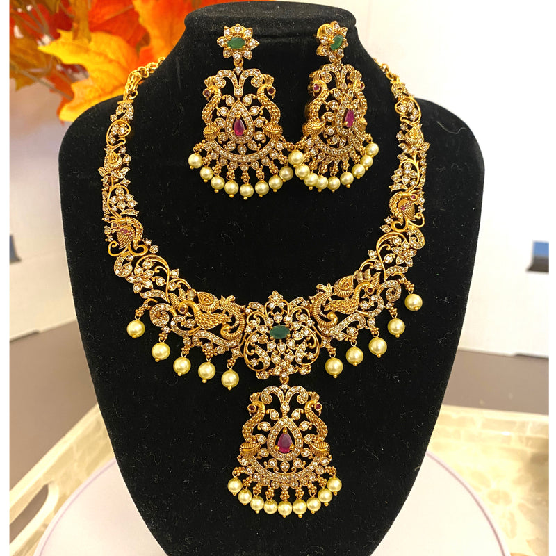 Traditional Indian Gold Necklace Set with CZ, ruby and emerald stones and pearls.