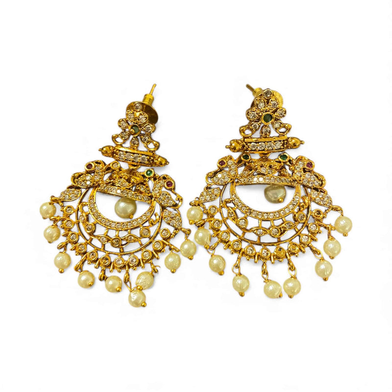 Gold CZ earrings designed with sparkling cubic zirconia, vibrant ruby stones, emerald accents, and elegant pearl drops. Traditional Indian bridal earrings with detailed gold plating and fine craftsmanship. Perfect for weddings, receptions, festivals, and party wear. High-quality South Asian earrings that pair beautifully with sarees, lehengas, and anarkalis. Ideal accessory for brides and special occasions.