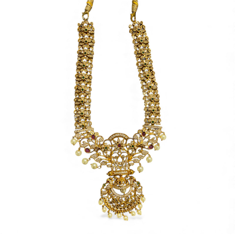 Gold CZ necklace featuring high quality cubic zirconia, ruby stones, emerald accents, and delicate pearl drops. Traditional Indian bridal necklace with intricate gold plating and detailed craftsmanship. Perfect statement piece for weddings, receptions, festivals, and cultural celebrations. Premium South Asian jewelry that pairs beautifully with sarees, lehengas, and anarkalis.