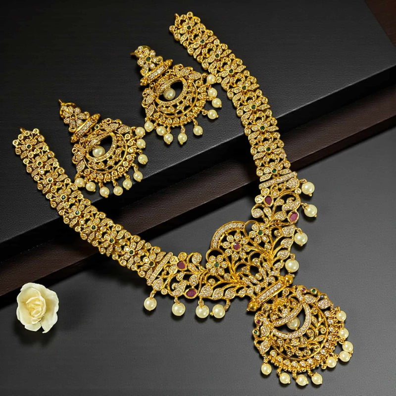 Gold CZ necklace set featuring high quality cubic zirconia, ruby stones, emerald stones, and pearl drops. Traditional Indian bridal jewelry with intricate gold plating and detailed craftsmanship. Perfect for weddings, receptions, festivals, and special occasions. Elegant South Asian necklace set that pairs beautifully with sarees, lehengas, and anarkalis. Ideal for brides, parties, and cultural events.
