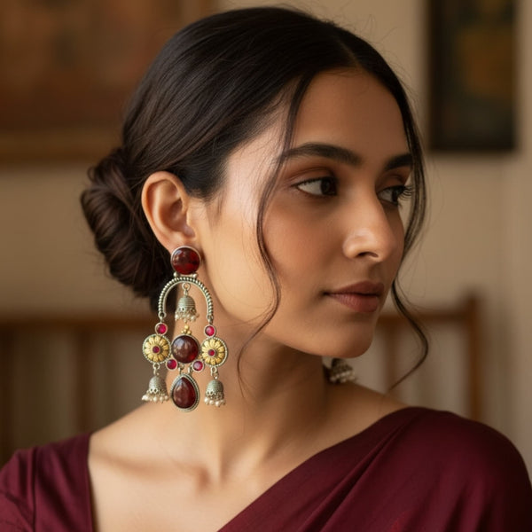 Woman wearing 925 silver-plated ruby chandbali earrings with jhumkas, showcasing intricate floral detailing, ruby stones, and oxidized silver finish. Premium Indian ethnic earrings perfect for weddings, festivals, and party wear.