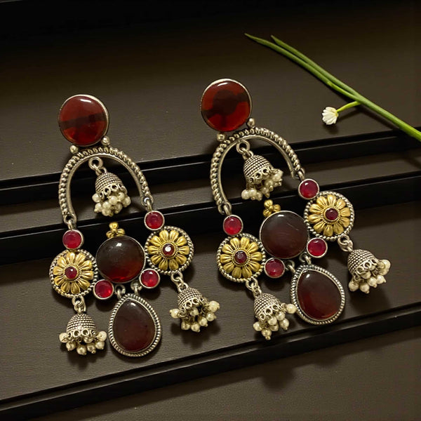 925 silver-plated ruby chandbali earrings with jhumkas displayed clearly to show intricate floral detailing, shimmering ruby stones, and oxidized silver craftsmanship. Elegant Indian ethnic earrings featuring traditional jhumka drops, perfect for weddings, festivals, parties, and cultural events. High-quality handcrafted jewelry with rich color, statement design, and premium finish