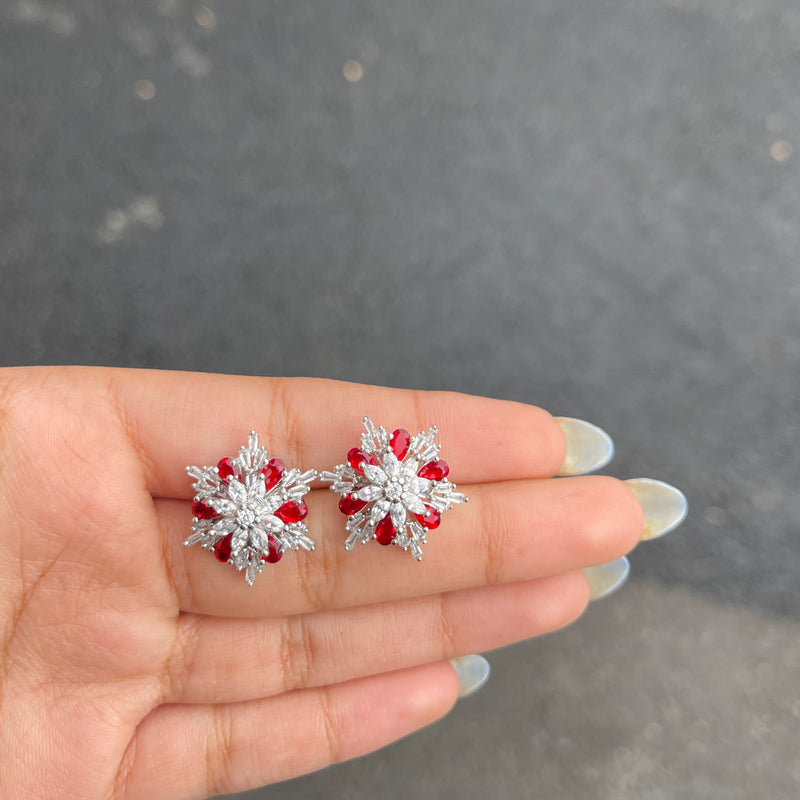 High quality studs handmade with high quality American Diamonds/Cubuc Zirconia featuring intricate placement of Ruby crystals on Rhodium Silver Finish.